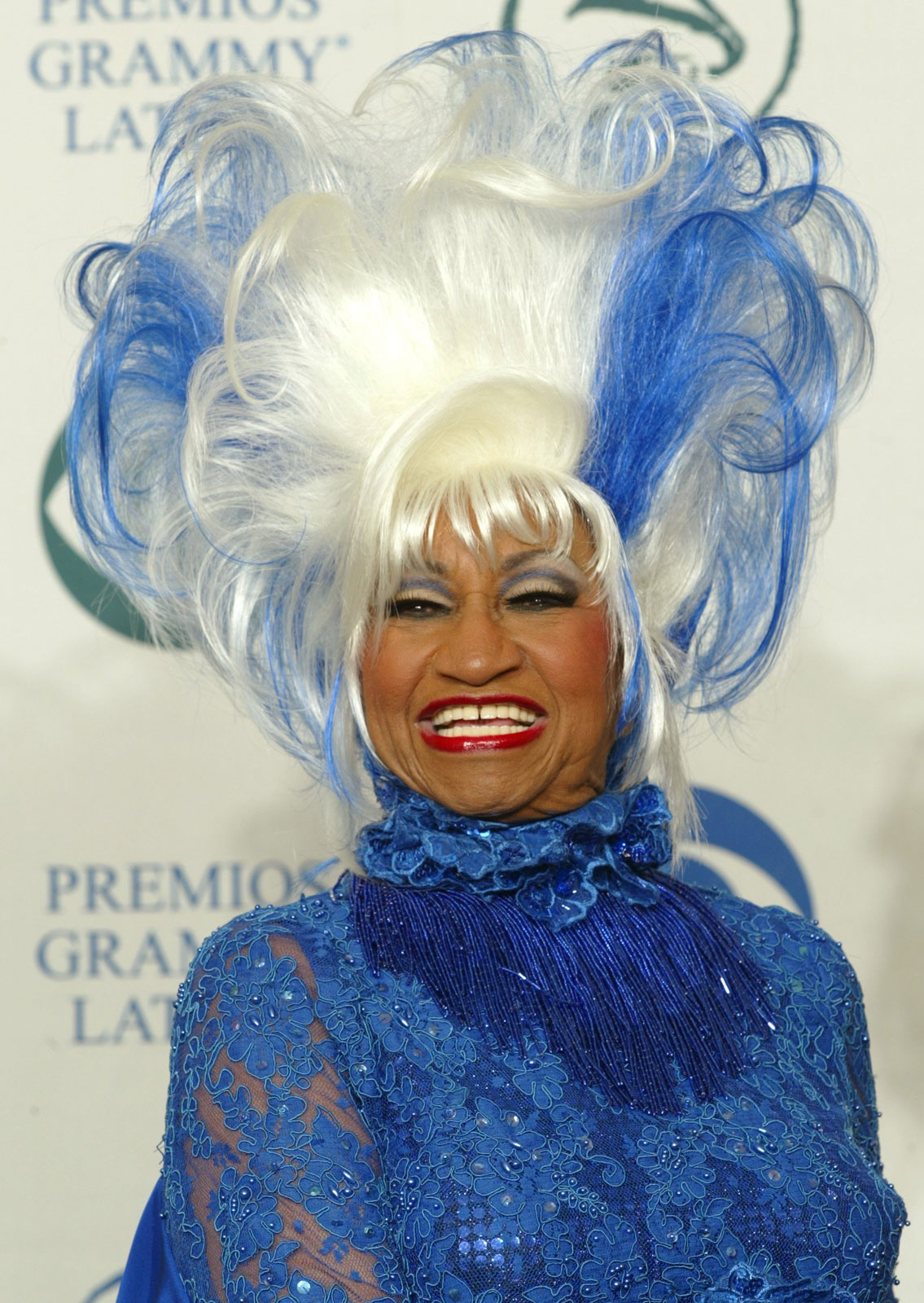 A headshot of Celia Cruz in vibrant blue